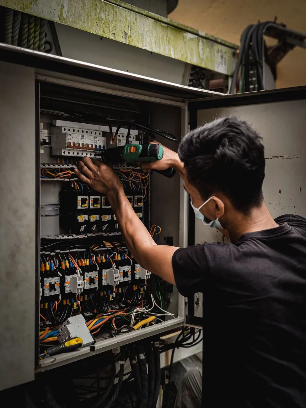 electrician working electrical panel